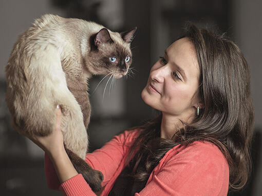 Woman holding up Cat